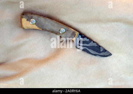 Damascus fixed blade knife for the hunter, farmer, gardener or knife collector enthusiast. The random Damascus pattern is quite pretty along with the Stock Photo