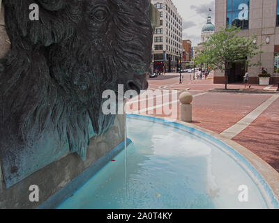 Water trickling from Bison Head Bronze Sculpture at Soldiers & Sailors Monument fountain, Indianapolis, Indiana, USA, July 26, 2019, © Katharine And Stock Photo
