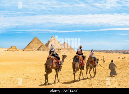 Camel riding near the Great Pyramids in Giza, Egypt Stock Photo