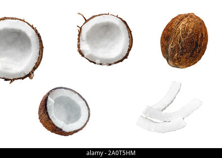 Whole coconut and chopped into chunks and chips on a light white wooden background. Top view Stock Photo