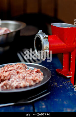 Manual vintage meat grinder and ripe tomatoes on the table. Making homemade  tomato sauce. Use of outdated kitchen utensils Stock Photo - Alamy