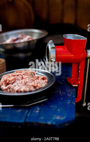 Manual vintage meat grinder and ripe tomatoes on the table. Making homemade  tomato sauce. Use of outdated kitchen utensils Stock Photo - Alamy