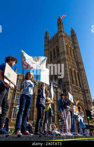 20 September 2019, London, UK - Young schoolchildren holding banners and signs, shouting in front of Houses of Parliament, Global Climate Strike in Westminster Stock Photo