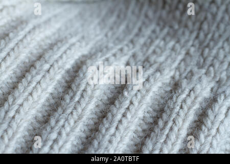 Extreme close up gray color knitted sweater made of natural wool texture, wavy folds, selective focus Stock Photo