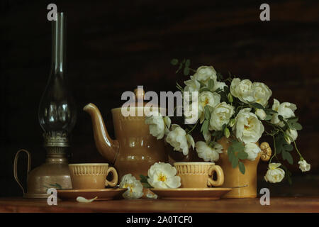 Still-life clay coffee cups with fresh white roses Stock Photo