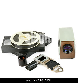 Old videocassettes and video projector with slides isolated on white background. Free space for text. Stock Photo