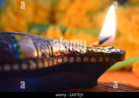 Close up selective focus of Diwali diya cotton wick glowing flame on Festive occasion to spread positivity and light Stock Photo