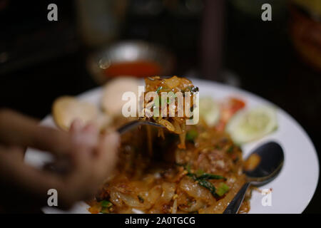 Asian stir frying spicy noodles, Mie Tiaw. Stock Photo