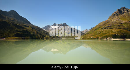 Scenic alpine landscape in summer. Silvretta Reservoir with mountain reflection, Vorarlberg, Austria. Stock Photo