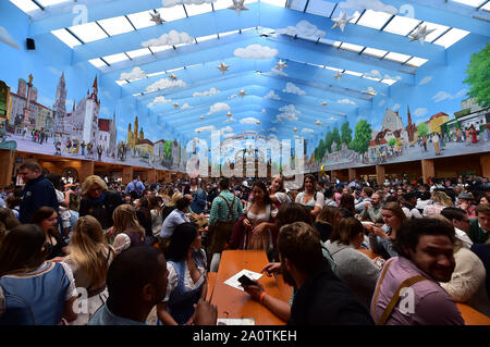Munich, Germany. 21st Sep, 2019. People visit a festival tent during the first day of the Oktoberfest 2019 in Munich, Germany, Sept. 21, 2019. The 186th Oktoberfest, one of the world's largest folk festivals, officially opened here on Saturday. It is expected that around 6 million visitors from all over the world will enjoy festival beer and culinary delicacies here from Sept. 21 to Oct. 6. Credit: Lu Yang/Xinhua/Alamy Live News Stock Photo