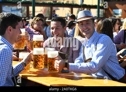 Munich, Germany. 21st Sep, 2019. People enjoy beer during the first day of the Oktoberfest 2019 in Munich, Germany, Sept. 21, 2019. The 186th Oktoberfest, one of the world's largest folk festivals, officially opened here on Saturday. It is expected that around 6 million visitors from all over the world will enjoy festival beer and culinary delicacies here from Sept. 21 to Oct. 6. Credit: Lu Yang/Xinhua/Alamy Live News Stock Photo