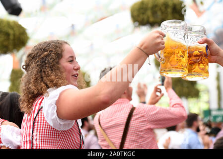 Munich, Germany. 21st Sep, 2019. A girl drinks beer during the first day of the Oktoberfest 2019 in Munich, Germany, Sept. 21, 2019. The 186th Oktoberfest, one of the world's largest folk festivals, officially opened here on Saturday. It is expected that around 6 million visitors from all over the world will enjoy festival beer and culinary delicacies here from Sept. 21 to Oct. 6. Credit: Lu Yang/Xinhua/Alamy Live News Stock Photo