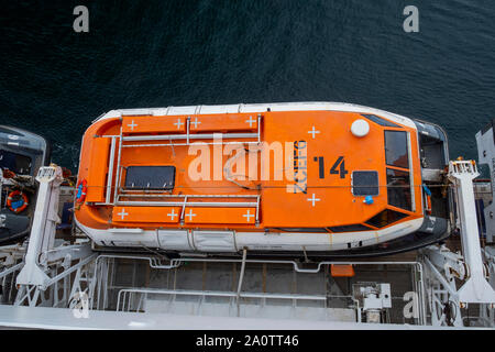 Queen Mary 2's lifeboats high up on the side of deck 8, above the normal height to protect them from huge Atlantic waves Stock Photo