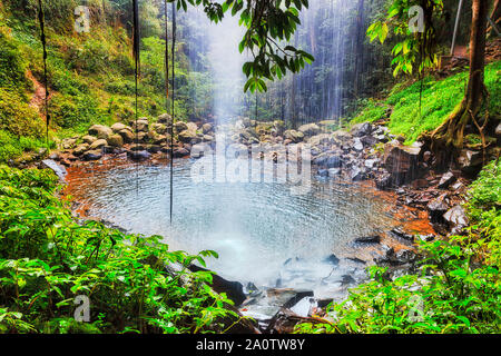 Inside waterfall - Crystal Fall in Dorrigo National park of AUstralia - ancient rainforest, part of Gondwana continent. Water stream falling down to r Stock Photo