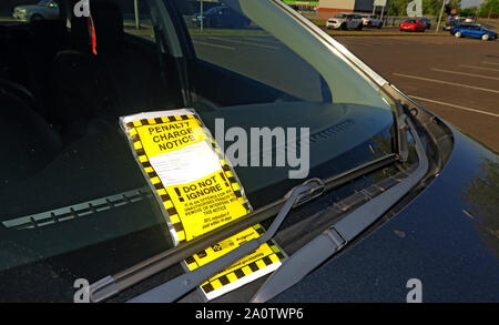 Yellow Parking Penalty Charge Notice on car windscreen under wiper, car park offence, not displaying a valid parking ticket, Sedgemoor, Taunton Stock Photo