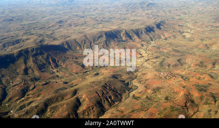 Deforested central highlands near Antananarivo, showing erosion gullies and rice terraces in valleys, Madagascar Stock Photo