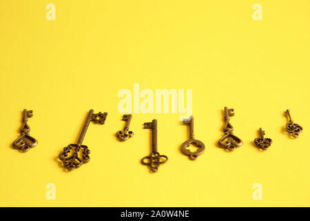 Different keys on yellow background. Choice and right solution concept Stock Photo