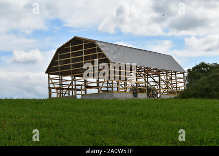 Barn under construction framed and partially complete on a farm in a rural area Stock Photo