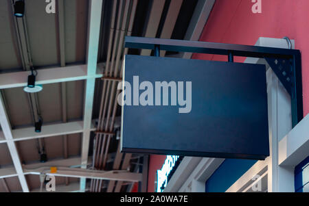 Mockup dark blue black signboard on the wall. Rectangular shape. Outdoor signage to add company sign or logo. Stock Photo