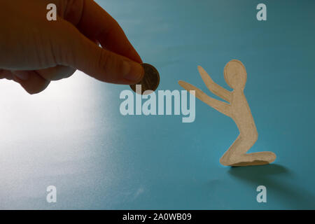 Beggar asks for help. Hand gives money to beggar Stock Photo