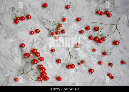 Cherry tomato pattern on a gray background. Flat lay. Top view. Stock Photo