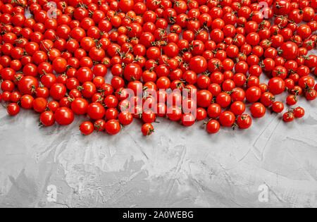 Cherry tomato pattern on a gray background. top view. Copy space. Stock Photo