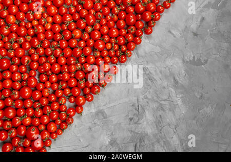 Cherry tomato pattern on a gray background. Flat lay, top view. Stock Photo