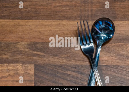 Artistic view of the fork and spoon on the table. Stock Photo