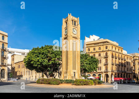 Al-Abed Nejmeh Square clock tower with tree and buildings around, Beirut, Lebanon Stock Photo