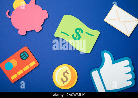 top view of scattered colorful paper icons on blue Stock Photo