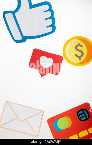 colorful paper icons with envelope, coin, credit card, hearts and thumb up on white background Stock Photo