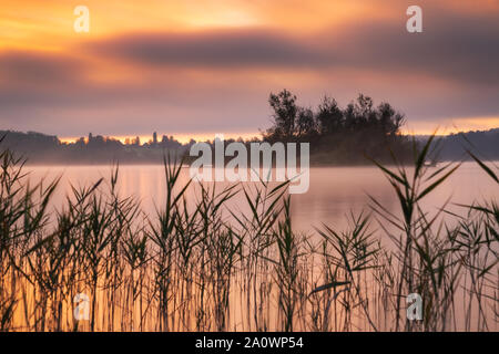 Sunrise at lake Ammersse. A beautifull morning with clouds in the sky and the sun coming up just over horizon. Stock Photo