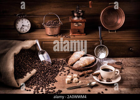 Homemade breakfast with a cup of black coffee sweetened with brown sugar and hot croissants.Still life Stock Photo