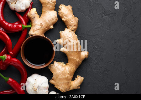 Schezwan Sauce ingredients at dark slate background with copy space. Schezwan Sauce is Indo-chinese or Sichuan cuisine hot sauce with red chilli, garl Stock Photo