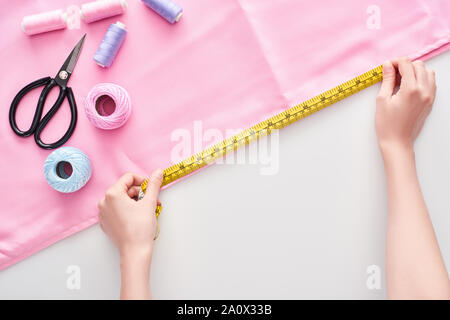Using measuring tape. Seamstress is in her office that is with different  clothes 15461389 Stock Photo at Vecteezy