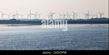 silhouette of wind turbine park on shore of north sea in german part ostfriesland Stock Photo
