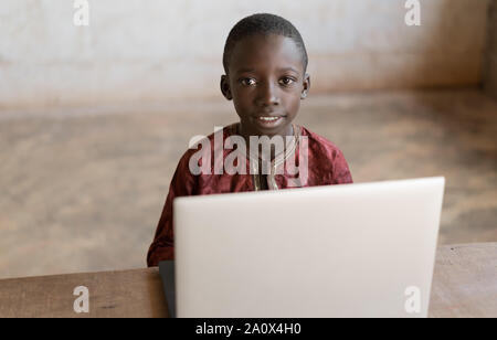 Gorgeous African Boy Portrait Shot Heads Up with Laptop Stock Photo