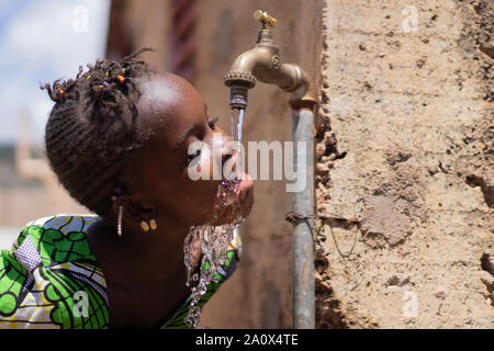 Water for Life, Black Girl drinking health symbol Stock Photo