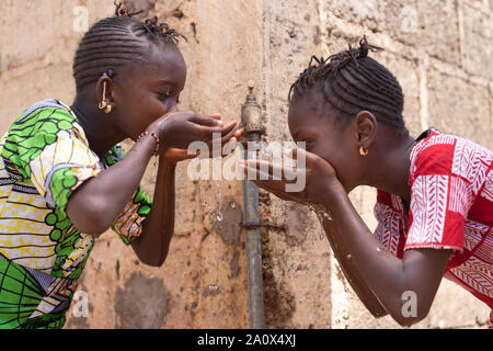 Fresh Water means Life for African Black Children Stock Photo