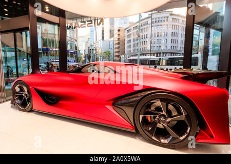 Nissan flagship showroom, Ginza, Tokyo. Display of the concept 2020 Granturismo car, on a revolving platform at glass fronted corner of building. Stock Photo