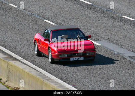 1990 red Ferrari 3405cc petrol Cabriolet; UK Vehicular traffic, transport, modern, saloon cars, south-bound on the 3 lane M6 motorway highway. Stock Photo