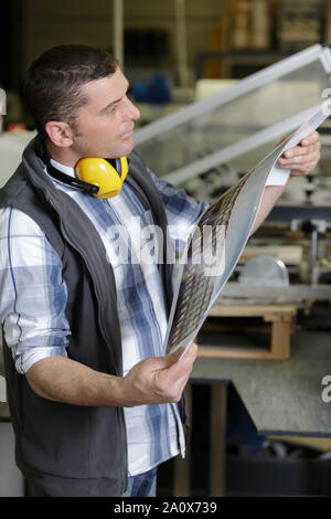 a man is checking printing quality Stock Photo