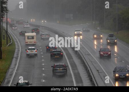 Flintshire, Wales, UK. 22nd September 2019. UK Weather:  With cooler temperatures and a yellow warning for rain today for western parts of the UK, autumn has arrived with winds and rain arriving from the remnants of Hurricane Humberto in the coming days. Motorists travelling along the A55 near Halkyn during heavy rainfall with a Met Office Yellow Warning for the area, Flintshire, UK Credit: DGDImages/AlamyLiveNews Stock Photo