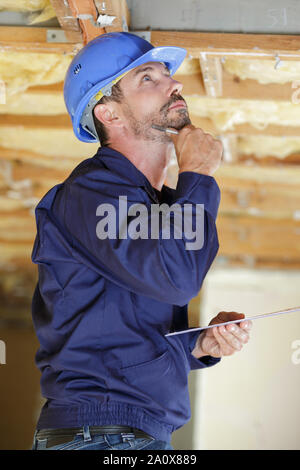 a pensive man builder thinking about something Stock Photo