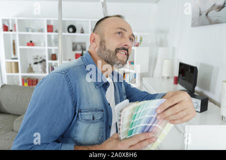 architects hand choosing color from various colorful swatches Stock Photo