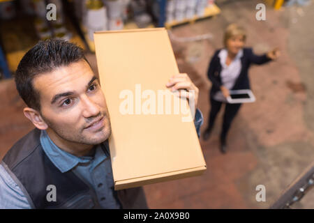 carpenter selecting wood in a hardware store Stock Photo