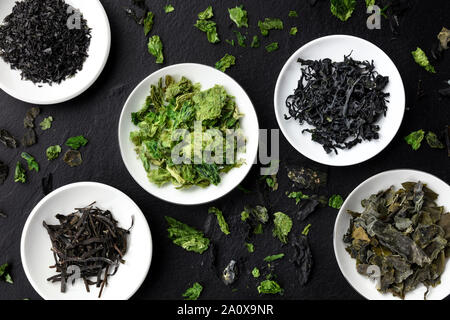 Various dry seaweed, sea vegetables, shot from above on a black background Stock Photo