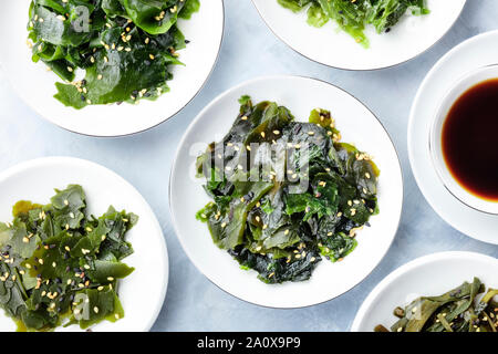 Various cooked seaweed, sea vegetables, shot from the top with a sauce and sesame seeds Stock Photo