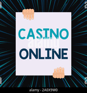 Handwriting text writing Casino Online. Conceptual photo Computer Poker Game Gamble Royal Bet Lotto High Stakes Two hands holding big blank rectangle Stock Photo