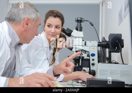 male and female scientists working in research facility Stock Photo